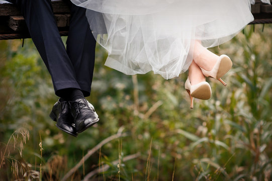 feet of bride and groom, wedding shoes