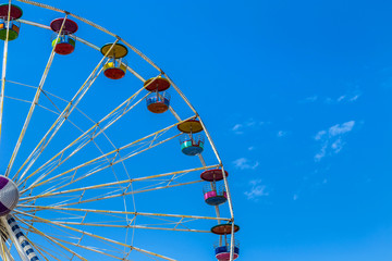 big colourful ferris wheel on blue sky background