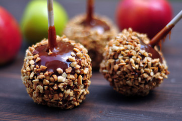 Apples in caramel with peanuts coating closeup