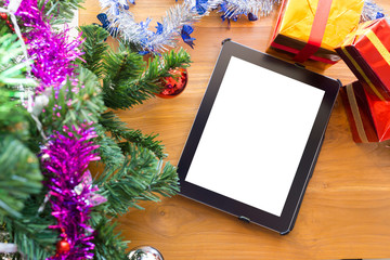 black tablet on table wood with christmas decoration