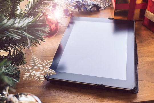 black tablet on table wood with christmas decoration
