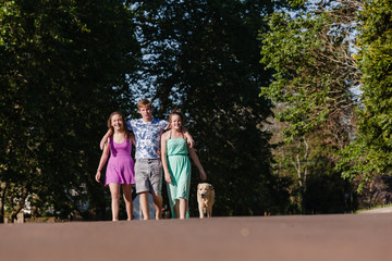Fototapeta premium Boy Girls Friends Walking Talking Dog