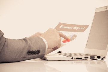 Businessman analyzing investment charts with laptop. Accounting