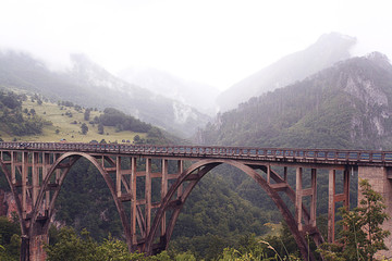 Fototapeta premium bridge in the mountains fog clouds rain