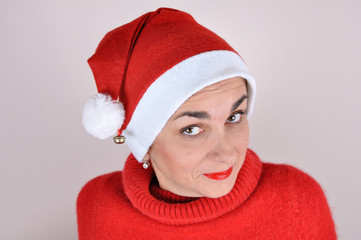 Portrait of a woman with Santa hat and a red turtleneck sweater