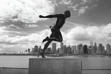 Stanley Park and Vancouver skyline. Harry Jerome sculpture. Cana - obrazy, fototapety, plakaty