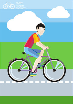 Man riding his bike on the road among green fields