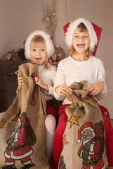 Little elves preparing bag for Santa Claus