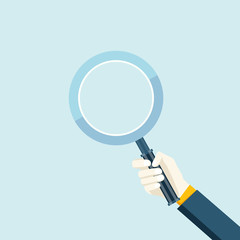 Magnifying glass in a hand