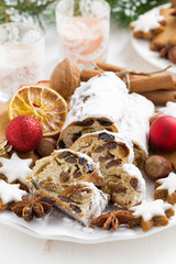 Christmas Stollen with dried fruit, cookies and spices on plate