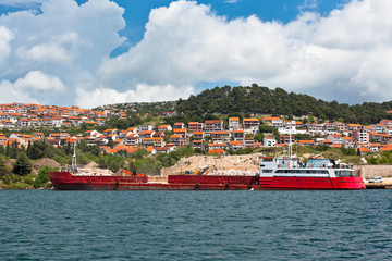 Fototapeta na wymiar Bulk carrier with Cargo near a River coast