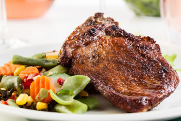 Fried pork with potatoes and vegetables salad