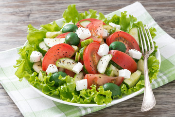 green salad with vegetables and feta on a plate