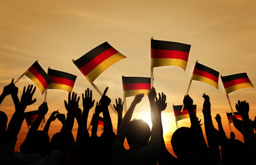 Silhouettes of People Holding Flag of Germany