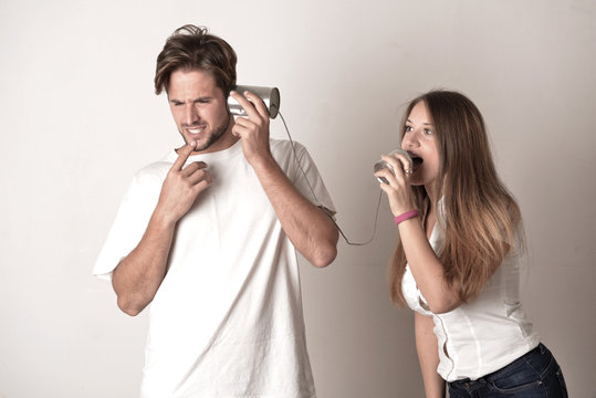 Couple talking through a tin phone