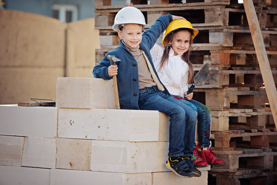 boy and girl playing on construction site