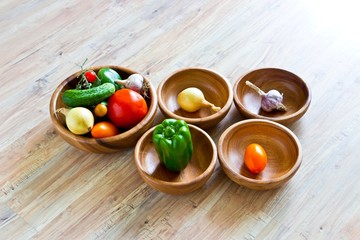 Fresh vegetables in wooden bowls