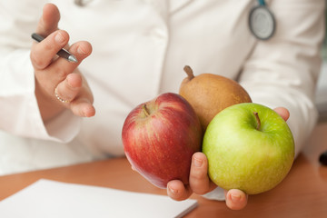 Nutrionist doctor holding fruits