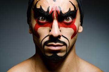 Man with face covered with facepaint