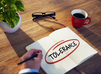 Businessman Writing the Word "Tolerance"