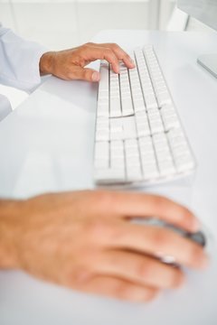 Close-up Of Hands Using Computer Keyboard