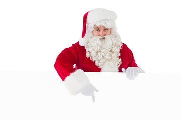 Joyful santa claus presenting sign