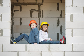 boy and girl playing on construction site