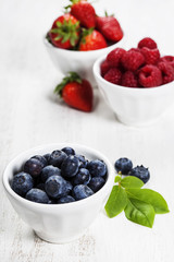 Berries in bowls  on Wooden Background.
