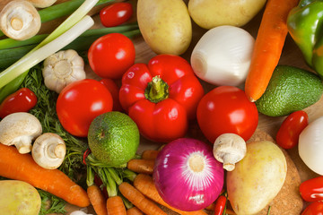 Different vegetables lying on a wooden table