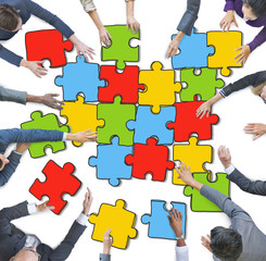 Group of People Forming Jigsaw Puzzles