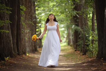 bride wedding a walk in the park in the woods