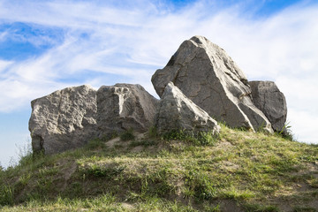 several large stones on sky background