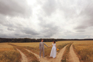 Fototapeta premium wheat field wedding bride and groom walk