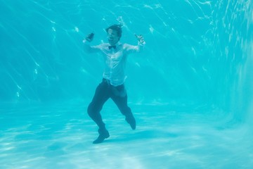 Young man swimming underwater
