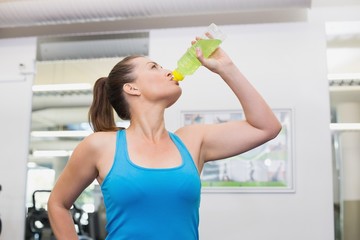 Fit brunette drinking energy drink