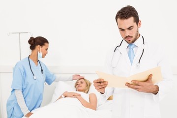 Doctor with colleague and patient behind