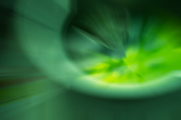 green and black color radial motion blur abstract