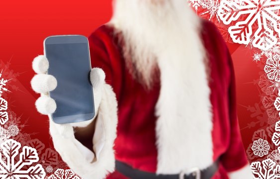 Composite image of santa claus showing smartphone