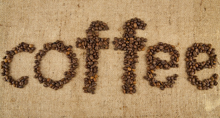 inscription from grains of coffee on rough woven