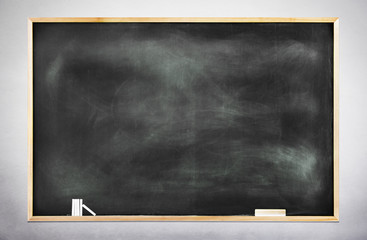 Textured Black Chalkboard with Chalks and Eraser