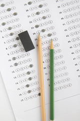 Standardized test form with answers bubbled in and a pencil, foc