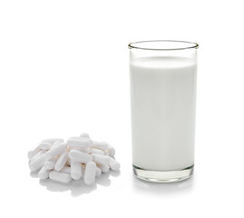 pill and glass of milk isolated on white background