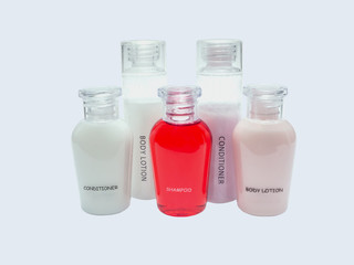 small bottles of shampoo, conditioner and body lotion isolated