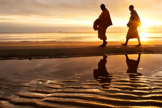 Monks walk on the Huahin beach