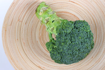 Fresh broccoli on wooden plate