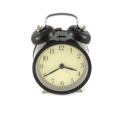 Alarm clock in black case shows about four o'clock