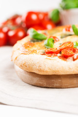 italian pizza on tablecloth with tomatoes vertical