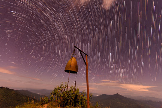 The Stars night of startails rises over the mountain and the bel