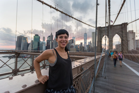 Happy Young Woman on Brooklyn Bridge