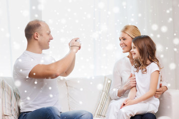 happy family with camera taking picture at home